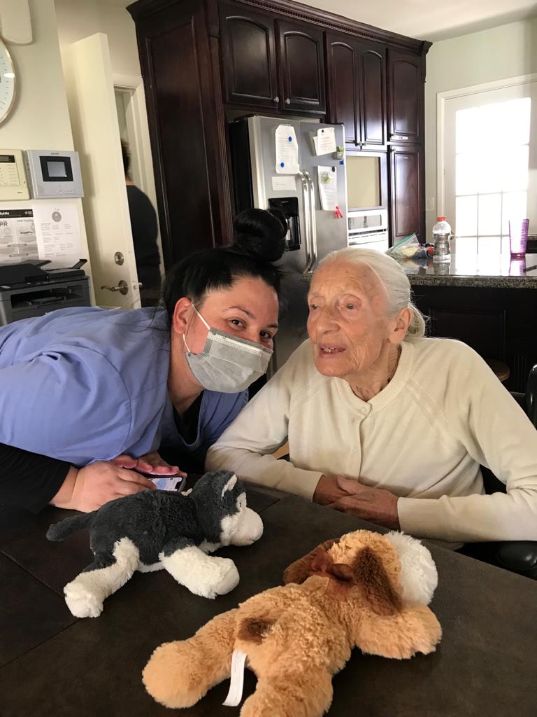 Elderly woman being assisted by a caregiver at Trinity Hills Estates, an assisted living facility in Arcadia, California